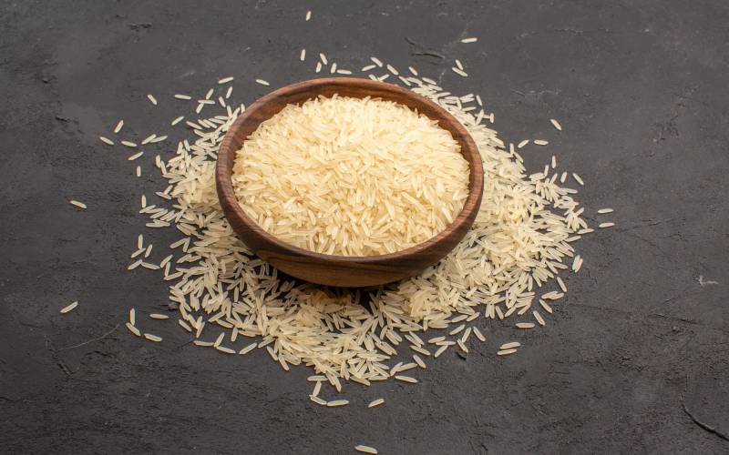 front-view-raw-rice-inside-plate-dark-grey-space