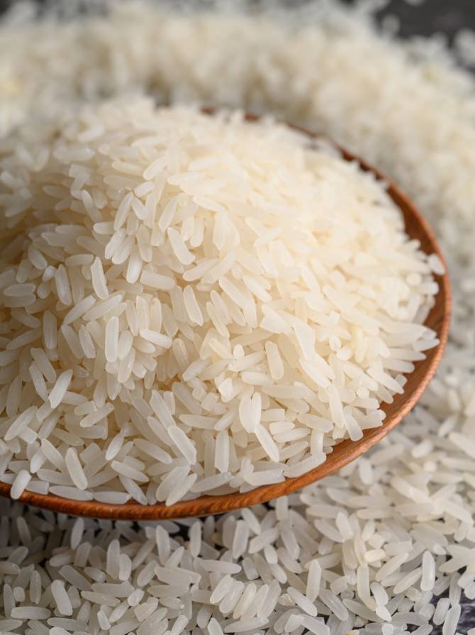 milled-rice-bowl-wooden-spoon-black-cement-floor